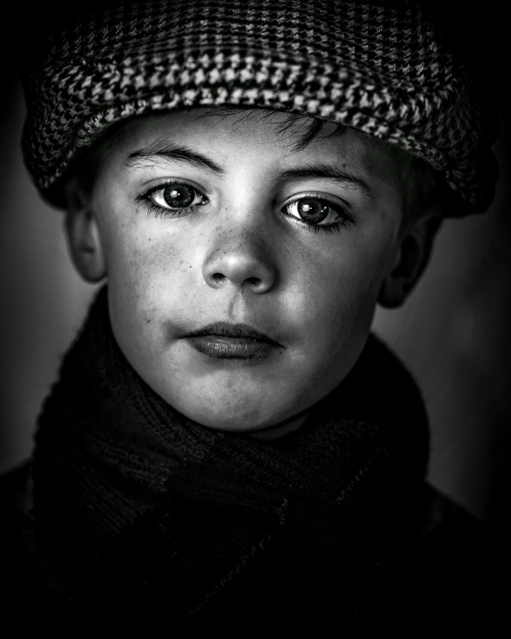 Portrait of an Irish boy with striking eyes, the ocean and far-off journeys behind his gaze.