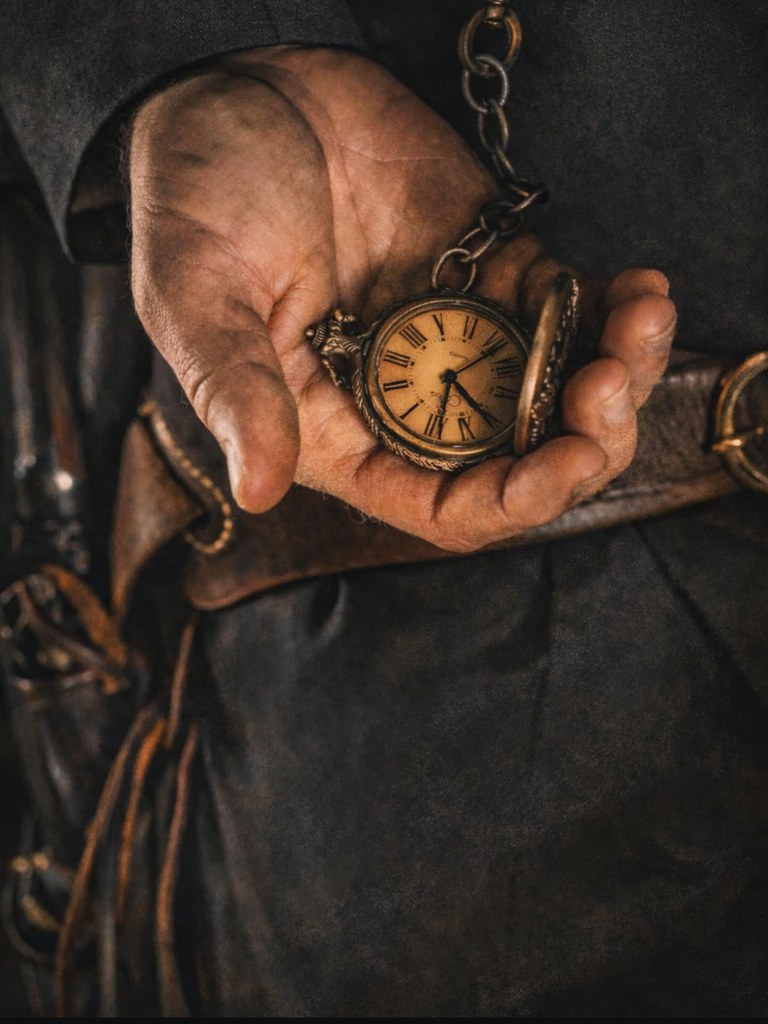 A weathered hand holding an old pocket watch, an echo of the gunslinger era of the American West.